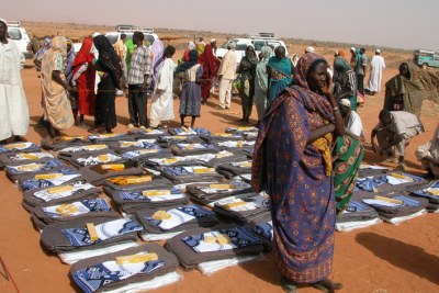 Receiving aid (file photo): The seven groups targeted by the decision are Accord, Goal, Triangle, Save the Children, Plan Sudan, Malo, a British demining group, and a Japanese aid group.