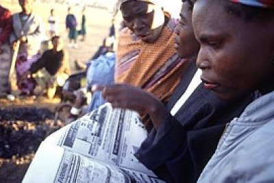 Women in Zambia read market price data published in a local newspaper (file photo).