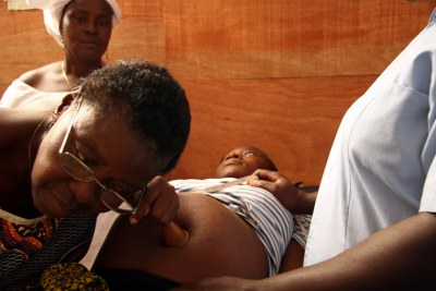 A pregnant woman is given a routine check-up at a clinic in Monrovia.