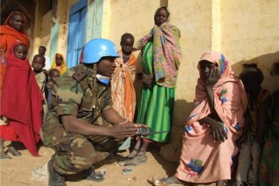A UN peacekeeper talks to locals in Darfur (file photo).