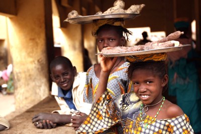 Children selling cassava roots in Mali.