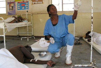 A health worker taking care of a patient.