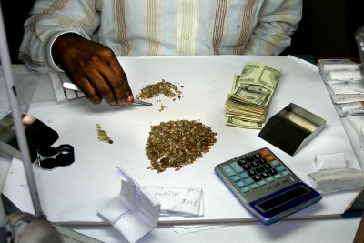 A wealthy dealer examines rough diamonds in his shop (file photo).
