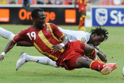 Emmanuel Agyemang-Badu of Ghana, front, clashes with Jonathan Pitroipa during the Burkina Faso-Ghana match on January 19 in Luanda.