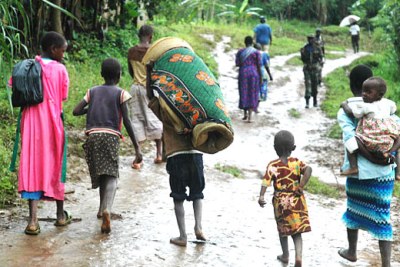Survivors flee the aftermath of a devastating landslide which displaced 300 000 people of the Mount Elgon region and neighbouring districts.