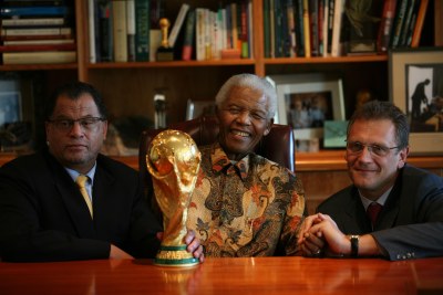 The late African icon Nelson Mandela (middle) and former FIFA secretary general Jérôme Valcke (right) posing with  World Cup trophy in Johannesburg (file photo).