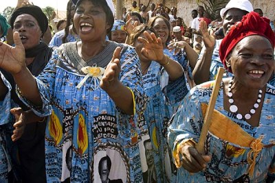 Cameroonian women, clad in dresses with the image of President Paul Biya,