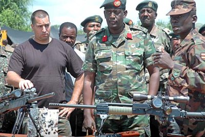Ugandan officers, headed by Brigadier James Mugira, and a counter-terrorism consultant identified as a Captain Barak inspect the weaponry that will leaders at the African Union summit in Kampala.