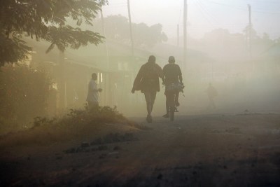 People travel along the dusty road from Kibondo to Kigoma, Tanzania.