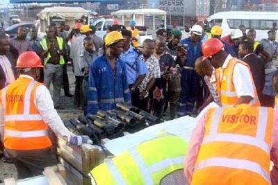 Members of Nigeria's State Secret Service offloading crates of rocket launchers intercepted in Lagos.