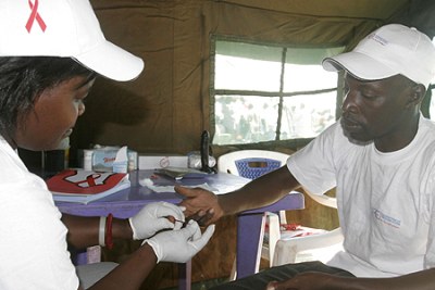 A counsellor takes a blood sample (file photo).