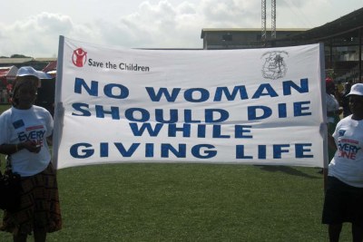 Women carrying banner