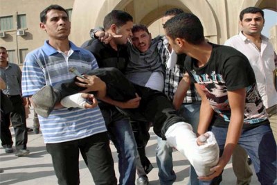 An injured demonstrator assisted by his friends (file photo).
