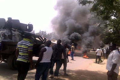 Smoke billows from the protest that followed yesterday's bomb attack at St Finbarr's Parish Rayfield, a Catholic church in Jos.