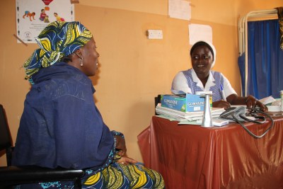 Health worker with a patient (file photo).