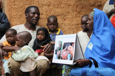 Binta, a Volunteer Community Mobilizer, has convinced Sabiu to get his children immunized against polio.