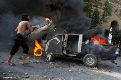Egyptian protestor sets police car on fire.