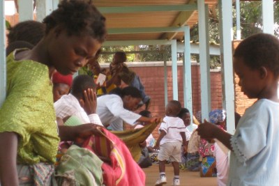 A mother and her child wait to see a nurse at Kawale Clinic in Lilongwe, Malawi.