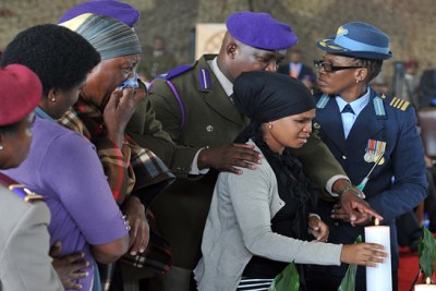 Family members light candles of remembrance at a memorial service for Fallen Heroes of the SANDF killed in Bangui, Central African Republic.