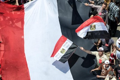 Members of opposition groups wave flags during an anti-President Mohamed Morsi rally at Tahrir Square in Cairo, capital of Egypt, on June 30, 2013.
