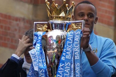 Man City captain Vincent Kompany holds up the Premier League trophy 2012.