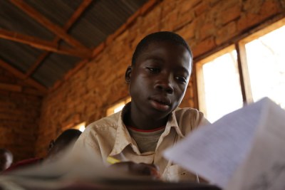 A 13-year-old boy, who mines gold, attends classes in a small-scale mining area in Mbeya Region, Tanzania. Work in mining impacts children’s performance and attendance at school.
