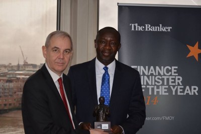 Minister Konneh receiving the Finance Minister of the Year Award from a London-based magazine's Senior Editor Brian Caplen (file photo)