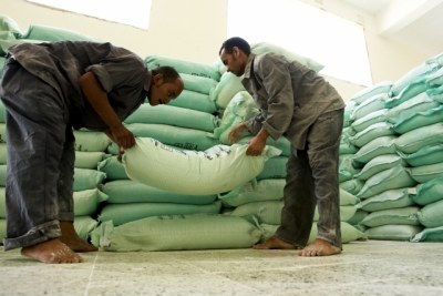 Mill workers stack sacks of flour (file photo).