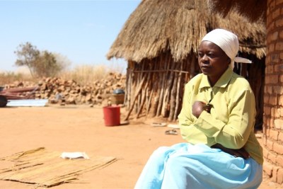 Amai Wadzanai Moyo sits outside her new home soon after being relocated from her village in south-eastern Zimbabwe's Masvingo Province to make way for construction of the Tokwe-Mukosi Dam.