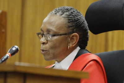 Judge Thokozile Masipa reads her verdict in the murder trial of paralympic athlete Oscar Pistorius in Pretoria.