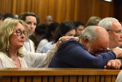 Barry, father of Reeva Steenkamp, cries and is consoled by his wife June, left, while listening to a witness recalling life with their daughter (file photo).