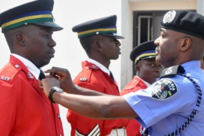 Inspector General of Police Mohammed  Abubakar dressing junior officer during handover ceremony at the Force Headquarters in Abuja (file photo).