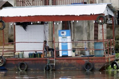A petrol pump attendant sits on a floating fuel station on the banks of the Nun River near Yenagoa, October 8.