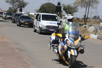The hearse carrying Zanele Moyo's body being escorted from the Harare International Airport.