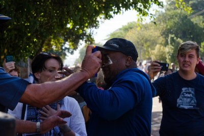 A Rhodes University staff member is pepper sprayed by a police officer after he joined a protest against rape culture.