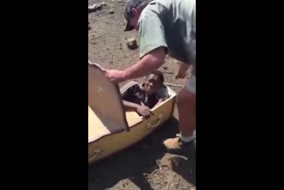 Screenshot from the video depicting Victor Mlotshwa being forced into a coffin.