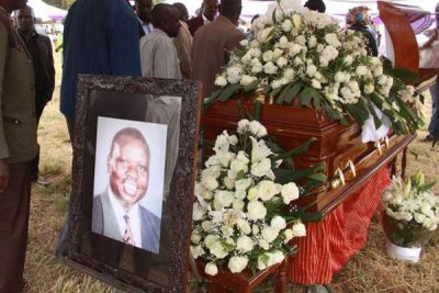 Mourners view the body of former nominated MP Mark Too.