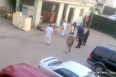 Police outside PREMIUM TIMES head office in Abuja during raid and arrest the newspaper’s publisher and a reporter.
