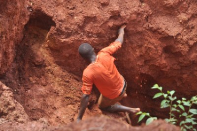 A youth miner entering a pit in Nabwal Mining Camp.