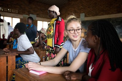 Justine Mbabazi, Social Empowerment Manager for Women for Women International, explains the content of a job skills class to Sophie Turner, in a local primary school in Mubano village, Rwanda.