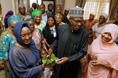 President Muhammadu Buhari is welcomed by his wife as he returns from a medical stay in London on March 10.