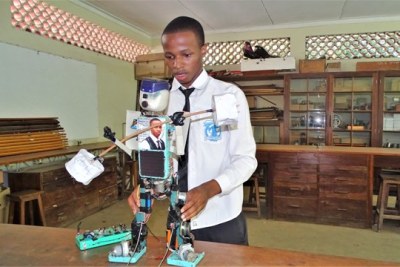 Form six student at Ilboru High School, Gracious Ephraim dispays his solar-powered human robot, which can walk, twist its head and speak at the Arusha-based school.
