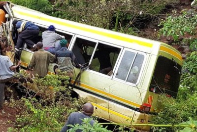 Good Samaritans remove the bodies of trapped pupils after a school bus plunged into Marera River Gorge in Karatu District.