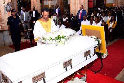 First Lady Janet Museveni lays a wreath on the casket containg the body of the proprietor and founder of St Lawrence Schools and Colleges, Lawrence Mukiibi during the requiem Mass at Rubaga Cathedral.