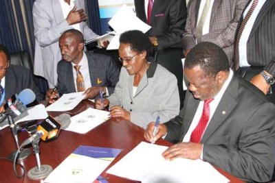 (From left) Kenya National Union of Teachers secretary general Wilson Sossion, chairman Mudzo Nzili and Teachers Service Commission chairperson Lydia Nzomo signing the salaries agreement at Teachers Service Commission headquarters, Nairobi.