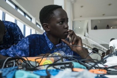 Aboubacar Savage, 14, from Gambia looks at a computer at the 2017 Pan-African Robotics Competition in Dakar, Senegal.