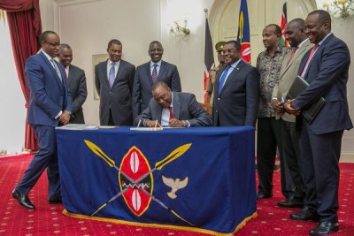 President Uhuru Kenyatta signs Supplementary budget in to law in at State House, Nairobi on October 13, 2017.