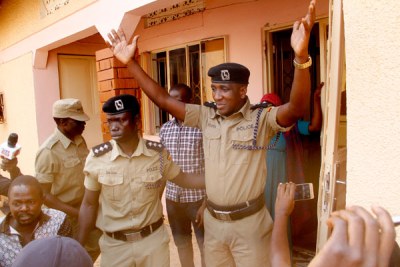 Former Buyende DPC Muhammad Kirumira surrenders to FSU officers during his arrest at his home on February 1, 2018.