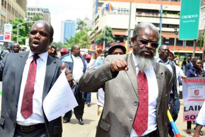 Universities Academic Staff Union Secretary-General Constantine Wasonga (left) and chairman Muga K'Olale demonstrate in Nairobi on November 8, 2017.