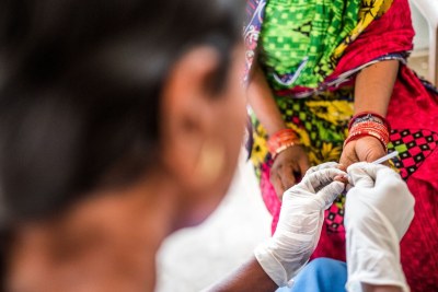 Woman taking a malaria test.